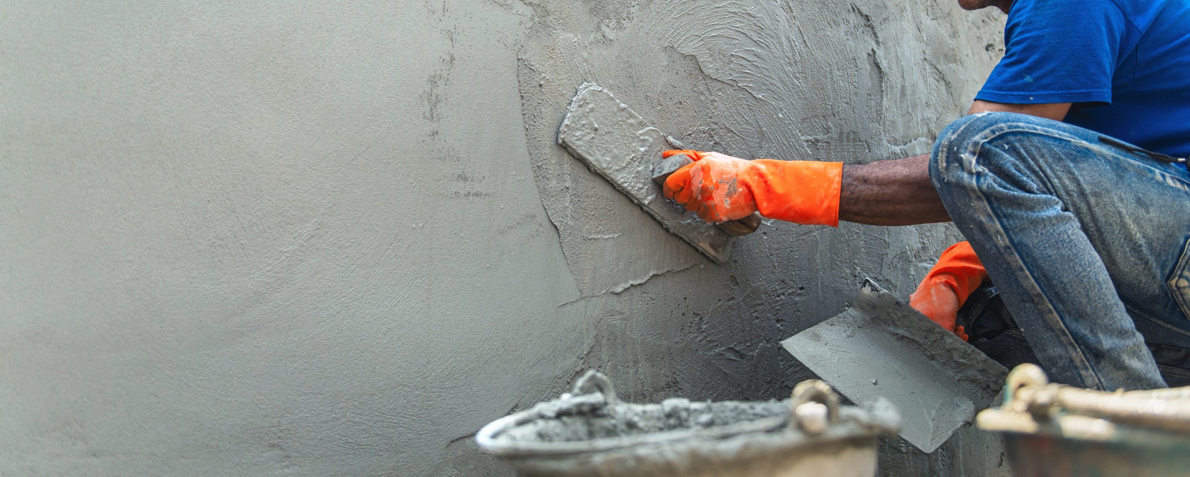 Rendered wall being smoothed by hand